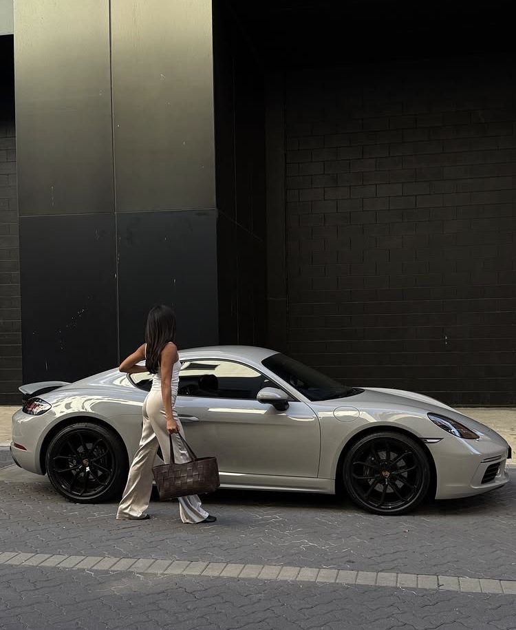 Walking past a silver luxury sports car